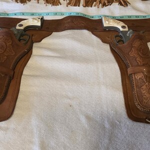 Vintage Child size Cowboy Holster and Toy cap guns. 1950 Leather good condition.