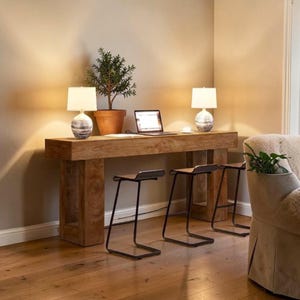 May include: A distressed wooden sign with the words "Welcome to our home" in white lettering. The sign has a rustic finish, ideal for adding a welcoming touch to a front door.