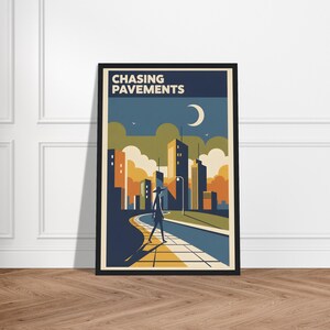May include: A framed art print featuring a stylized cityscape with a person walking on a path. The artwork has a retro aesthetic, with a color palette of blues, oranges, and yellows. The words "CHASING PAVEMENTS" are at the top.