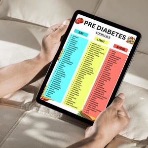 May include: A tablet displaying a "Pre Diabetes Food List" with categories: Eat, Limit, and Avoid. The list includes various food items like spinach, brown rice, and soda. The tablet is held by a person.