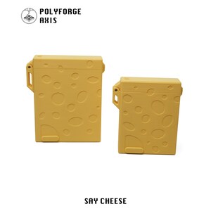 May include: Two yellow rectangular storage cases with a Swiss cheese-inspired design featuring various circular indentations. Each case has a hinged lid and a side latch mechanism. The text POLYFORGE AXIS and SAY CHEESE are visible in the image.
