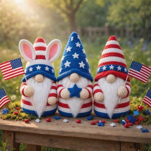 May include: Three patriotic gnomes with white beards and red, white, and blue outfits. One gnome wears bunny ears, while the others have pointed hats. Each holds an American flag. Decorative stars and berries are scattered on the wooden surface.