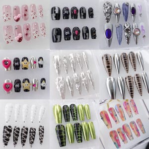 May include: A collection of various press-on nail sets. Designs include pink nails with bows and stars, black nails with cartoon faces, silver metallic nails, and nails with animal print patterns. Some sets feature rhinestones and metallic accents.