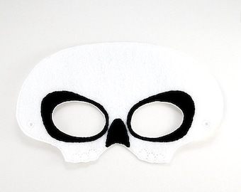 May include: White felt skull mask with black eye holes and nose. The mask has two small holes on the sides for attaching to a headband.