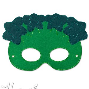 May include: Green felt mask with a dark blue flower design. The mask has eye holes and is designed for children.