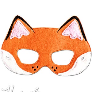 May include: Orange felt fox mask with black eyes and white felt accents. The mask has pink felt ears and black stitching around the edges.