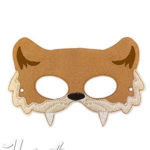 May include: A brown felt animal mask with white fur trim and black eyes. The mask has a pointy nose and two large teeth.