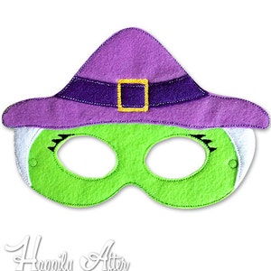 May include: Green felt witch mask with a purple felt hat and a gold buckle. The mask has white felt around the eyes and black eyelashes.