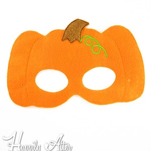 May include: Orange felt pumpkin mask with eye holes and a green stem. The mask is designed for children and is perfect for Halloween costumes.
