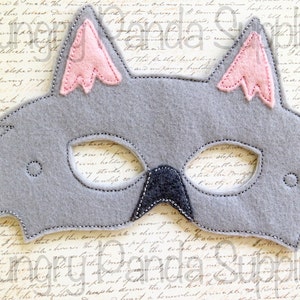 May include: Gray felt animal mask with pink felt ears. The mask has eye holes and a stitched outline.
