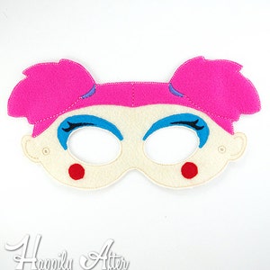 May include: A felt mask with pink hair, blue eyes, and red cheeks. The mask is designed to look like a girl.