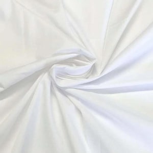 May include: Close-up of white fabric with gentle folds and shadows. The fabric looks smooth and possibly lightweight, with a slight sheen. The folds create depth and texture, suggesting a flowing material. Ideal for clothing or home decor.
