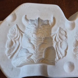 May include: A set of three ceramic mugs with a speckled, matte finish in cream, light grey, and dark grey. Each mug features a simple, minimalist design, ideal for coffee or tea.