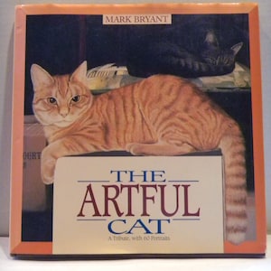May include: The Artful Cat: A Tribute, with 60 Portraits book cover featuring a painting of an orange tabby cat lying on a box with a black cat sleeping on a shelf above.