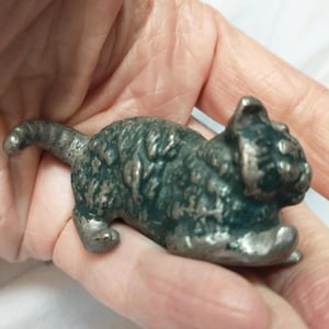 Heavy vintage silver colored metal cat figurine with applied green paint..pouncing cat figure