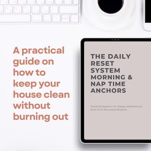 May include: A white desk setup with a keyboard, coffee cup, and tablet. The tablet displays text: "THE DAILY RESET SYSTEM MORNING & NAP TIME ANCHORS." Text on the left reads: "A practical guide on how to keep your house clean without burning out."