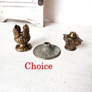 May include: A set of three ceramic mugs with a speckled, matte finish. The mugs are in shades of cream, light gray, and dark gray. Each mug has a simple, minimalist design and a rounded handle.