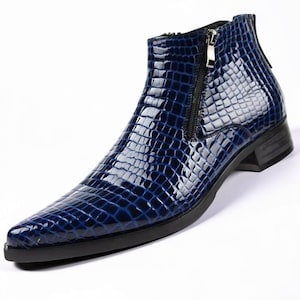 May include: A shiny, navy blue ankle boot with a textured, crocodile-like pattern. The boot features a pointed toe, a side zipper, and a small heel. The overall design is sleek and modern, suitable for formal or semi-formal occasions.