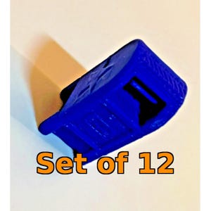 May include: A small, solid blue plastic component with a rectangular base and a hollow center, featuring a textured surface. The object is presented as a set of 12, with the text "Set of 12" displayed in orange letters at the bottom of the image.