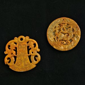 May include: A white ceramic mug with a black handle and the text "But First, Coffee" in a black, bold font. The mug is on a white surface.