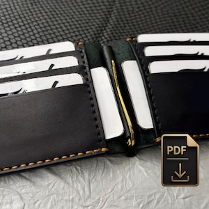 Könnte beinhalten: Ein schwarzes Leder-Bifold-Portemonnaie mit kontrastierenden hellbraunen Nähten, mehreren Kartenfächern mit weißen Karten und einer zentralen goldfarbenen Metall-Geldklammer. Der Markenname Fibich ist unten rechts eingeprägt.