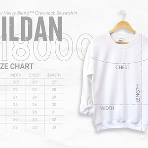 May include: A white Gildan 18000 crewneck sweatshirt displayed on a wooden hanger. The image includes a size chart with measurements in inches for width, chest, and length. The text "Unisex Heavy Blend Crewneck Sweatshirt" is visible.