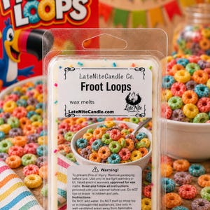 May include: A clear plastic clamshell package containing white wax melts with colorful sprinkles. The label reads LateNiteCandle Co. Froot Loops, wax melts, LateNiteCandle.com, and includes a warning and instructions for use.