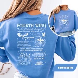 May include: Carolina blue sweatshirt featuring text from "Fourth Wing" by Rebecca Yarros. The design includes quotes, dragon illustrations, and the words "Basgiath War College." The sweatshirt has a crew neck and long sleeves.