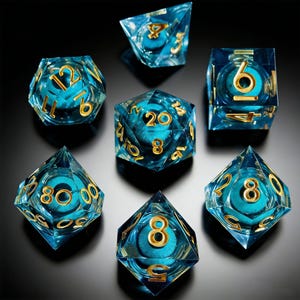 May include: A collection of seven polyhedral dice. Each die is made from clear blue resin with gold numerals. The dice have a teal-colored interior design. The dice are displayed on a dark surface, highlighting their various geometric forms.