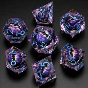 May include: A set of seven polyhedral dice with a fantasy theme. Each die is clear with a purple and blue interior design, and blue numbering. The dice are arranged on a black surface.