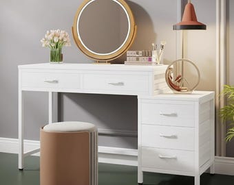 May include: A white vanity set with a round, gold-framed mirror with a built-in light. The set includes a matching stool with a brown base and a white top, and a three-drawer cabinet. A vase of flowers sits on the vanity.