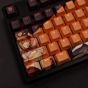 May include: A black mechanical keyboard with orange keycaps and anime-style illustrations. The keyboard has a standard QWERTY layout with function keys and number keys. The keycaps are backlit. The keyboard is designed for gaming.