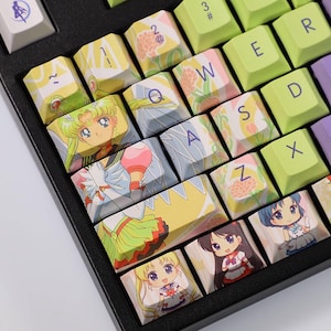 Può includere: Una tastiera nera con tasti personalizzati con illustrazioni di personaggi anime. I tasti mostrano vari personaggi in colori vivaci, con lettere e simboli in diversi caratteri. La tastiera ha un mix di colori pastello e vivaci.