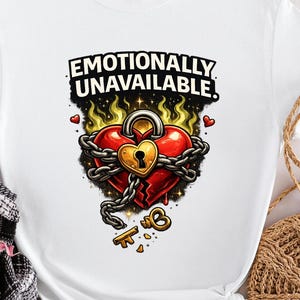 May include: White t-shirt with the text "Emotionally Unavailable." The graphic features a red heart with a lock and chain design, a key, and flames. The shirt is a casual wear item.