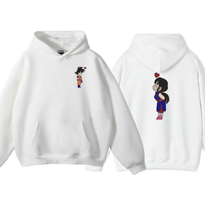 May include: Two white hoodies with matching cartoon graphics. One hoodie features a character on the front, the other on the back. The graphics are of a cartoon character with a heart above their head. The hoodies have a front pocket and a hood.