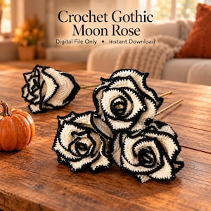 May include: Three crochet roses with cream-colored petals and black edges, each attached to a thin stem. The text Crochet Gothic Moon Rose Digital File Only Instant Download is visible above the flowers, next to a small orange pumpkin.