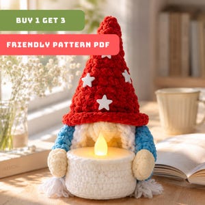 May include: A handmade crochet gnome with a red hat adorned with white stars, blue sleeves, and a white beard. The gnome holds a white candle holder with a glowing LED candle. The text "BUY 1 GET 3" and "FRIENDLY PATTERN PDF" are visible.