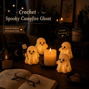 May include: Four small, cream-colored crochet ghost figures with black eyes and smiles, one holding a tiny marshmallow on a stick. They are arranged around a lit pillar candle on a dark wooden surface with an open book and glasses nearby.