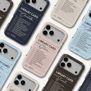 May include: A collection of smartphone cases in various colors including navy, light blue, beige, pink, and brown. Each case features a printed library card design with a borrower name, a numbered list of book titles, and the word BOOKED at the bottom.