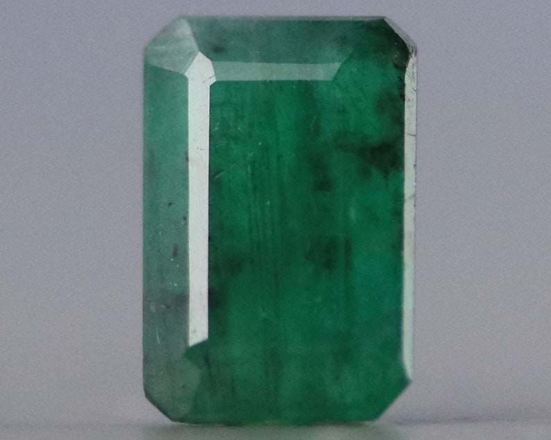 Vibrant faceted emerald gemstone with deep green hues, symbolizing love, prosperity, and protection. Ideal for fine jewelry designs, collectors, and energy healing practices.
