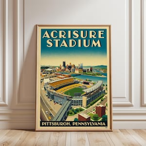 May include: A framed poster featuring a stylised illustration of Acrisure Stadium in Pittsburgh, Pennsylvania. The artwork displays the stadium, the city skyline, and a river in shades of yellow, blue, and green with bold text at the top and bottom.