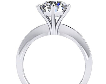 May include: A silver solitaire engagement ring with a round brilliant cut diamond.