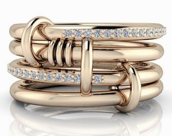 May include: A gold ring with a unique knot design and a row of small diamonds on each band.