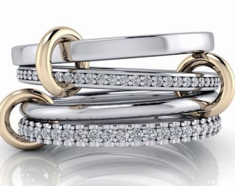 May include: A multi-band ring with a gold band and three silver bands, each set with a row of small diamonds.