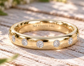 May include: A polished yellow gold band featuring a series of evenly spaced, flush-set round brilliant-cut diamonds around the exterior. The interior of the ring is clearly engraved with the text Bel Viaggio 14kt, indicating the metal purity.