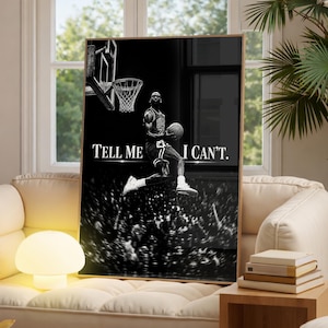 May include: A black and white rectangular wall art print featuring a basketball player mid-air about to dunk a basketball. The text "TELL ME I CAN'T." is printed in white capital letters across the center. A basketball hoop is visible above.