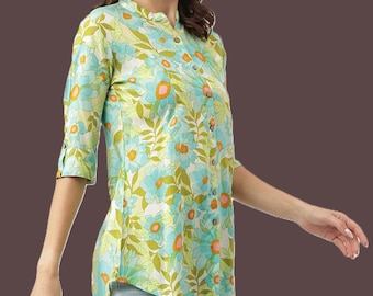 May include: A floral print shirt with a mandarin collar and three-quarter sleeves. The shirt features a pattern of large blue and orange flowers with green leaves on a light green background. The shirt has wooden buttons and is paired with light blue jeans.