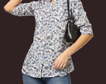 May include: White floral print shirt with a mandarin collar and three-quarter sleeves. The shirt features a pattern in blue, brown, and purple. The shirt is worn with blue jeans.