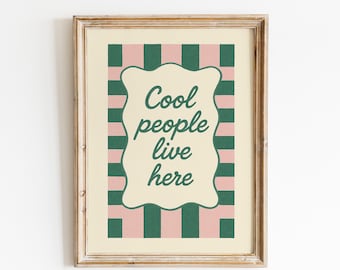 May include: Framed art print with the text "Cool people live here." The artwork features a cream-colored background with a pink and green striped border. The text is in a dark green, stylized font.