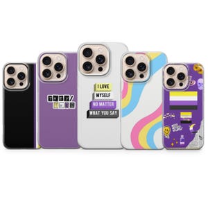 May include: A collection of five phone cases with various designs. One case is black, another purple with "THEY/THEM" text, a white case with "I LOVE MYSELF NO MATTER WHAT YOU SAY", a case with pastel rainbow stripes, and a purple case with non-binary flag.